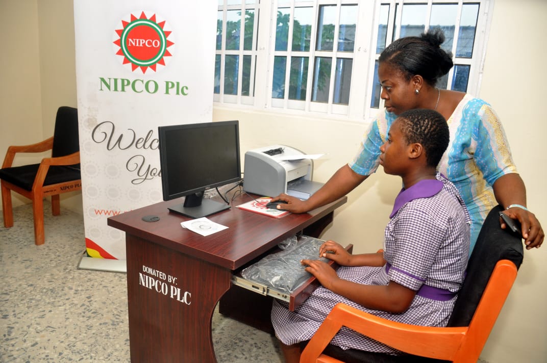 NIPCO staff assisting a student at the computer lab